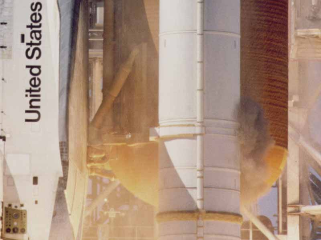 A puff of black smoke escapes the starboard SRB at launch, indicating the failure of the 0-ring. The failed O-ring allowed super-heated gases to escape and burn through the external fuel tank and ignite the fuel inside. (NASA)